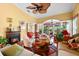 Bright living room with a fireplace, unique decor, and a ceiling fan at 1312 Perico Point Cir, Bradenton, FL 34209