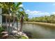 View of waterfront with vegetation and elevated deck, highlighting a serene outdoor space at 1312 Perico Point Cir, Bradenton, FL 34209