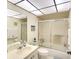 Well-lit bathroom featuring a tiled shower and glass door, and ample vanity storage at 1314 57Th W St # 1314, Bradenton, FL 34209