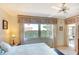 Well-lit bedroom with a bed, large window, and ceiling fan for maximum comfort at 1314 57Th W St # 1314, Bradenton, FL 34209