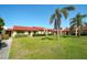 Charming exterior view of the townhomes with well-maintained landscaping and red tile roofs at 1314 57Th W St # 1314, Bradenton, FL 34209
