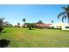 Landscaped exterior view of the community townhomes featuring a manicured lawn and mature trees at 1314 57Th W St # 1314, Bradenton, FL 34209