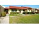 Inviting one-story home featuring a vibrant red tile roof and manicured lawn at 1314 57Th W St # 1314, Bradenton, FL 34209