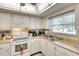 Well-lit kitchen with white cabinetry and views to the exterior at 1314 57Th W St # 1314, Bradenton, FL 34209
