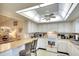 Bright kitchen featuring white cabinets, and modern appliances at 1314 57Th W St # 1314, Bradenton, FL 34209
