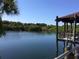 Picturesque view of the lake from the community gazebo, surrounded by lush greenery at 1314 57Th W St # 1314, Bradenton, FL 34209