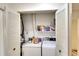 Laundry area with appliances, shelving, and bifold doors that maximize space at 1314 57Th W St # 1314, Bradenton, FL 34209