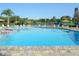 Large community swimming pool with plenty of lounge chairs and tables with umbrellas at 1314 57Th W St # 1314, Bradenton, FL 34209