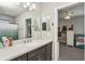 This bathroom has a large vanity and mirror with views of another bedroom at 13708 Old Creek Ct, Parrish, FL 34219