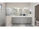 Modern bathroom with a double vanity, gray cabinetry, and a glass-enclosed shower with tile surround at 13708 Old Creek Ct, Parrish, FL 34219
