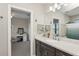 This bathroom has a vanity, an attached mirror, and a view of the bedroom at 13708 Old Creek Ct, Parrish, FL 34219