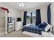 This bedroom includes a large window, ceiling fan and a white dresser at 13708 Old Creek Ct, Parrish, FL 34219