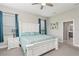 Calming main bedroom featuring a white wood bed frame, side tables, and blue accents at 13708 Old Creek Ct, Parrish, FL 34219