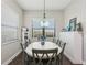 Light-filled dining room with an oval table, seating for six, and a bright window view at 13708 Old Creek Ct, Parrish, FL 34219