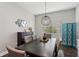 Formal dining room featuring a dark wood table with seating for six, and modern lighting at 13708 Old Creek Ct, Parrish, FL 34219