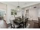 Formal dining room featuring a dark wood table with seating for six, with stairs to the second floor at 13708 Old Creek Ct, Parrish, FL 34219