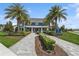 Stunning exterior of a home with palm trees and lush landscaping at 13708 Old Creek Ct, Parrish, FL 34219