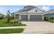 Charming home featuring a well-manicured lawn and a two-car garage, offering both curb appeal and practicality at 13708 Old Creek Ct, Parrish, FL 34219