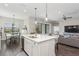 Bright kitchen with a central island, barstool seating, and modern appliances, perfect for culinary adventures at 13708 Old Creek Ct, Parrish, FL 34219