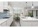 Bright open kitchen with white cabinets, stainless steel appliances, an island and a breakfast nook at 13708 Old Creek Ct, Parrish, FL 34219