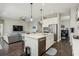 Open concept kitchen with stainless steel appliances, an island and barstool seating connects to the living room at 13708 Old Creek Ct, Parrish, FL 34219