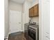 This laundry room offers wood-look tile, storage cabinets, and modern appliances at 13708 Old Creek Ct, Parrish, FL 34219