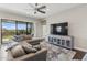 Comfortable living room with a large sectional sofa, entertainment center, and sliding glass doors to the patio at 13708 Old Creek Ct, Parrish, FL 34219