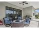Covered patio with grill and comfortable seating for outdoor living and entertaining at 13708 Old Creek Ct, Parrish, FL 34219