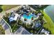 Aerial view of a luxurious pool area with lush landscaping and ample seating in a well-maintained community at 13708 Old Creek Ct, Parrish, FL 34219