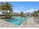 Inviting community pool with ample lounge chairs, lush landscaping, and well-maintained facilities on a sunny day at 13708 Old Creek Ct, Parrish, FL 34219
