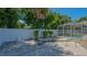 Private backyard area, featuring a screened pool, patio, and decorative white gravel at 1461 Porpoise Rd, Venice, FL 34293