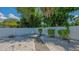 Enclosed backyard with stone walkway, minimal landscaping, and white vinyl privacy fence at 1461 Porpoise Rd, Venice, FL 34293