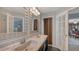 Bathroom features a double sink vanity, tiled floors, decorative mirrors, and gray paint at 1461 Porpoise Rd, Venice, FL 34293