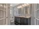 Bathroom features a double sink vanity, tiled floor, decorative mirrors, and gray paint at 1461 Porpoise Rd, Venice, FL 34293