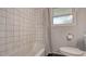 Bathroom features a bathtub with white tile and a shower curtain, and a gray accent wall at 1461 Porpoise Rd, Venice, FL 34293
