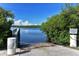 Community boat ramp providing access to the water with lush vegetation surrounding the area at 1461 Porpoise Rd, Venice, FL 34293