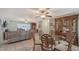 Open-concept dining room featuring a decorative wooden hutch, glass table, and views of the living room and kitchen at 1461 Porpoise Rd, Venice, FL 34293
