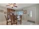 Elegant dining room with decorative wooden hutch, glass table, and tiled floors at 1461 Porpoise Rd, Venice, FL 34293
