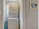 Laundry room features a stacked washer and dryer, and neutral paint at 1461 Porpoise Rd, Venice, FL 34293