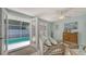 Bright and airy sunroom featuring wicker furniture, French doors leading to the pool area at 1461 Porpoise Rd, Venice, FL 34293