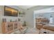 Cozy living room area with tile floors, a large TV, and an open bar area, perfect for relaxation and entertainment at 1461 Porpoise Rd, Venice, FL 34293