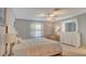 Well-lit bedroom features neutral colors, plush carpeting, and a ceiling fan at 1461 Porpoise Rd, Venice, FL 34293