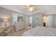 Comfortable bedroom with a ceiling fan, plush carpet, and view to the en-suite bathroom at 1461 Porpoise Rd, Venice, FL 34293