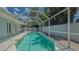 Refreshing pool with screened enclosure, perfect for enjoying outdoor swimming in a private backyard setting at 1461 Porpoise Rd, Venice, FL 34293
