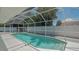 Sparkling pool enclosed by a screened lanai, offering a private oasis for swimming and relaxation at 1461 Porpoise Rd, Venice, FL 34293