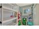Organized storage room with shelving, hooks, and ample space for storing beach chairs and seasonal decorations at 1461 Porpoise Rd, Venice, FL 34293