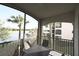 Relaxing screened-in balcony with a table and chairs offering views of the lake at 16904 Vardon Ter # 208, Lakewood Ranch, FL 34211