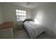 Comfortable bedroom with a single bed, a nightstand, and a window for natural light at 16904 Vardon Ter # 208, Lakewood Ranch, FL 34211