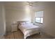 Well-lit bedroom with a window and a comfortable bed with soft striped bedding at 16904 Vardon Ter # 208, Lakewood Ranch, FL 34211