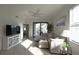 Bright living room featuring a comfortable sectional couch and a sliding glass door to a balcony at 16904 Vardon Ter # 208, Lakewood Ranch, FL 34211